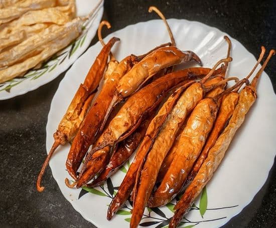 Challa Mirchi — golden fried buttermilk-marinated dried Andhra chillies on white plate