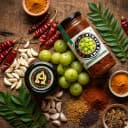 Fresh ingredients for Andhra Store Amla Pickle — red chillies, garlic, curry leaves and whole spices