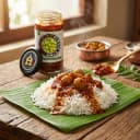 Amla Pickle served on hot steaming rice on banana leaf — traditional Andhra style