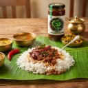 Curry Leaves Pickle served on hot steaming rice on banana leaf — traditional Andhra style