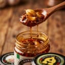 Garlic Pickle — close-up of spiced oil and pickle pieces on wooden spoon
