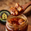 Ginger Pickle — close-up of spiced oil and pickle pieces on wooden spoon