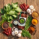 Fresh ingredients for Andhra Store Gongura Pickle — red chillies, garlic, curry leaves and whole spices