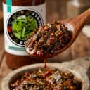 Gongura Pickle — close-up of spiced oil and pickle pieces on wooden spoon
