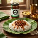 Green Chilli Pickle served on hot steaming rice on banana leaf — traditional Andhra style