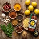 Fresh ingredients for Andhra Store Lemon Pickle — red chillies, garlic, curry leaves and whole spices