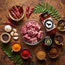 Fresh ingredients for Andhra Store Mutton Pickle — red chillies, garlic, curry leaves and whole spices