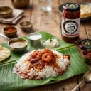 Prawn Pickle served on hot steaming rice on banana leaf — traditional Andhra style