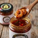 Prawn Pickle — close-up of spiced oil and pickle pieces on wooden spoon
