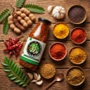 Fresh ingredients for Andhra Store Tamarind Pickle — red chillies, garlic, curry leaves and whole spices