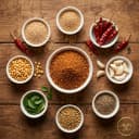 Fresh ingredients for Andhra Store reddish-brown sesame spice — roasted lentils, Guntur chilli and whole spices