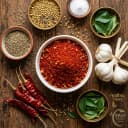 Fresh ingredients for Andhra Store red chilli garlic podi — roasted lentils, Guntur chilli and whole spices